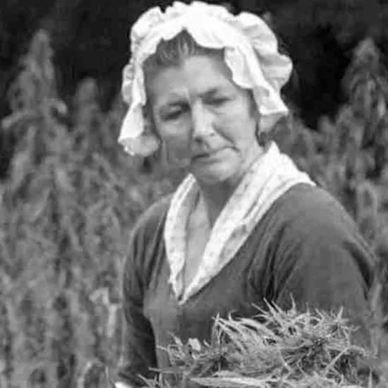 Black and white photograph of a woman working in a field