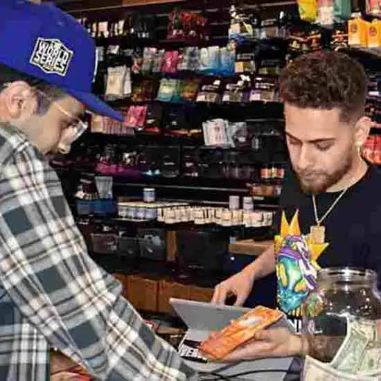 Budtender with a customer at 7 Engines