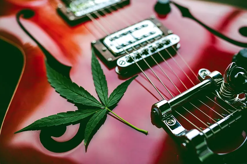 Shiny electric guitar with a marijuana leaf