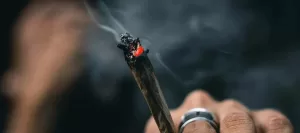 Close up of a pre-roll joint with smoke.