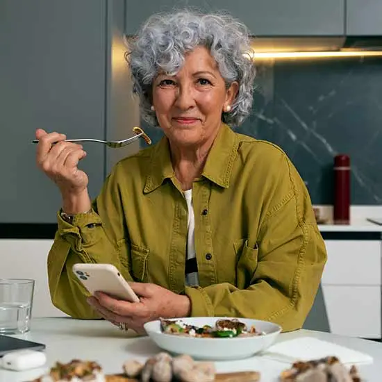Cannabis helps improve appetite. A senior lady enjoying a meal.