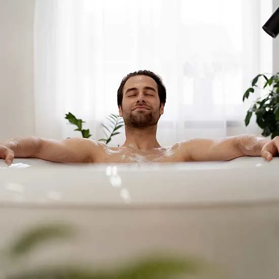 Man sitting in bath tub