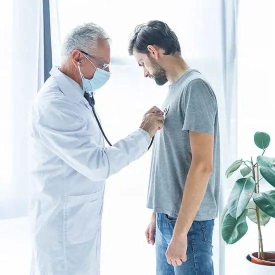 Doctor checking a patient with COPD, using a stethoscope