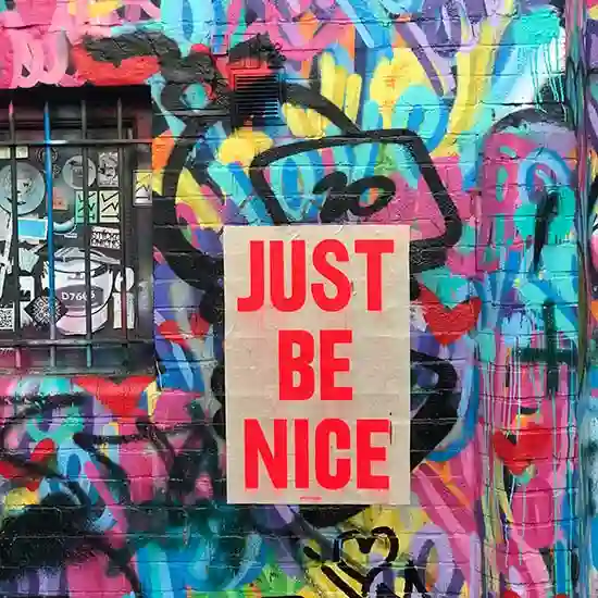 The words JUST BE NICE displayed on a wall on World Kindness Day